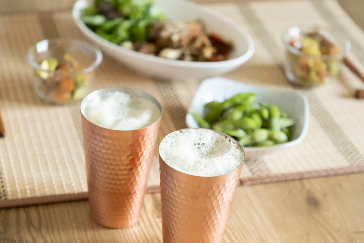 Copper tumblers on table