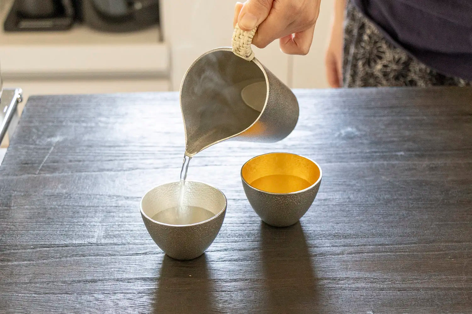 Pouring hot sake into cup